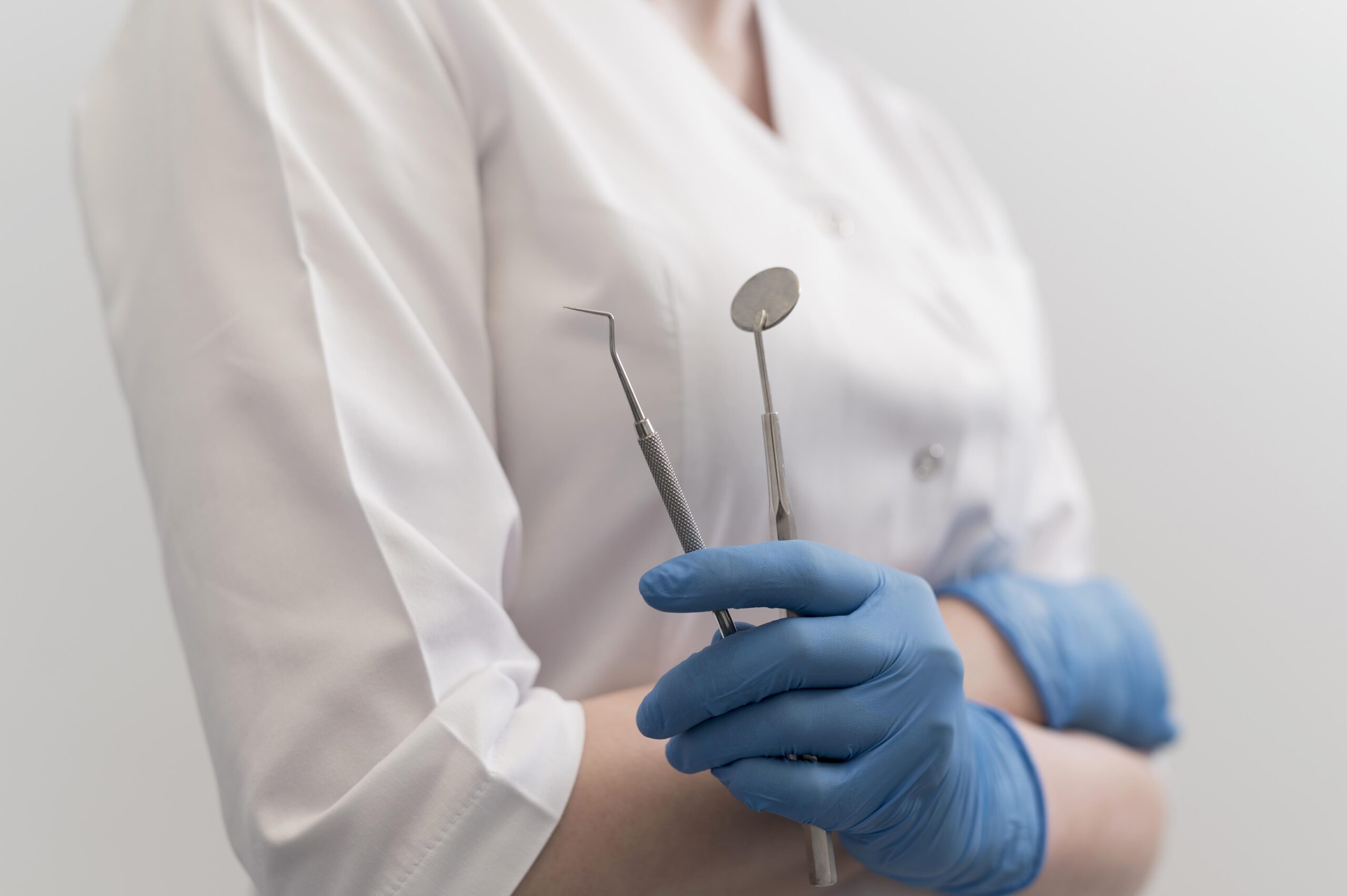 female-orthodontist-with-latex-gloves-handling-dental-equipment